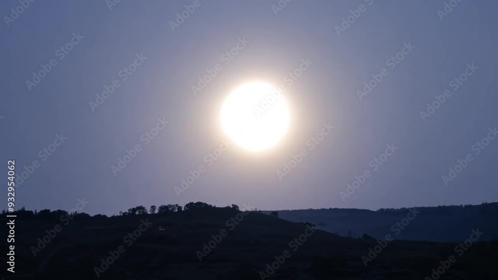 Bright sun setting over distant hills during dusk Bright sun setting over distant hills during dusk