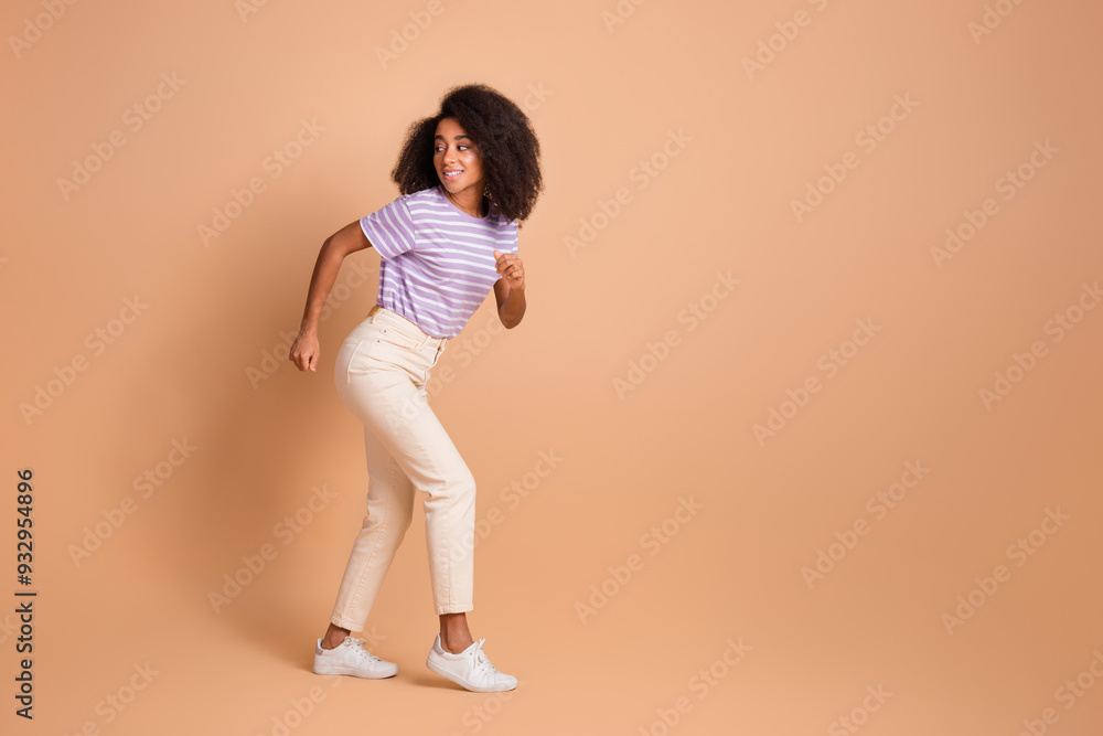 Full length portrait of pretty young woman run empty space wear t-shirt isolated on beige color background Full length portrait of pretty young woman run empty space wear t-shirt isolated on beige color background