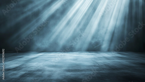 Soft beams of light illuminate a dark, foggy space creating a dramatic atmosphere