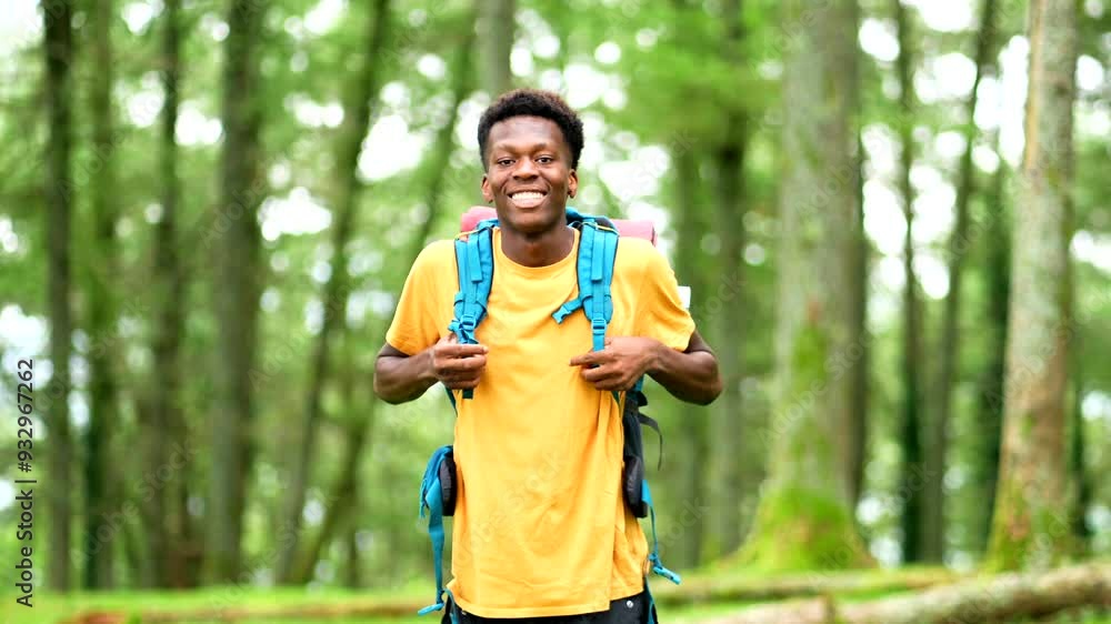 Portrait of a cheerful young african man hiking through green forest Portrait of a cheerful young african man hiking through green forest