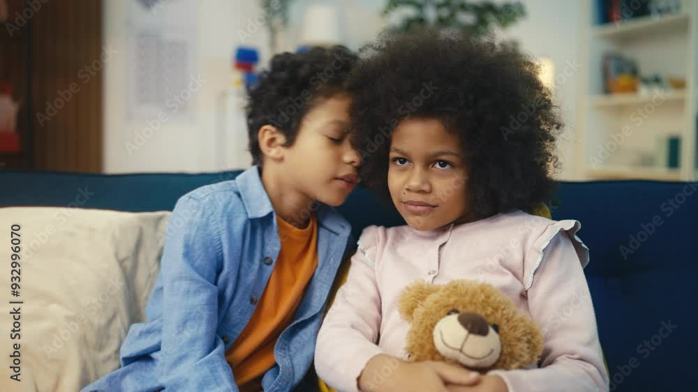 Little African American boy whispers secrets to his friend, they laugh together Little African American boy whispers secrets to his friend, they laugh together