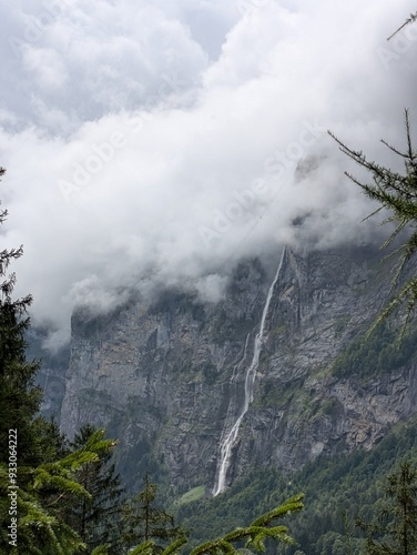 Huge Swiss waterfall on a mountain on a cloudy day