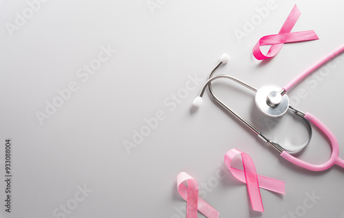 Pink ribbon and stethoscope on paper background for supporting breast cancer awareness month campaign.
