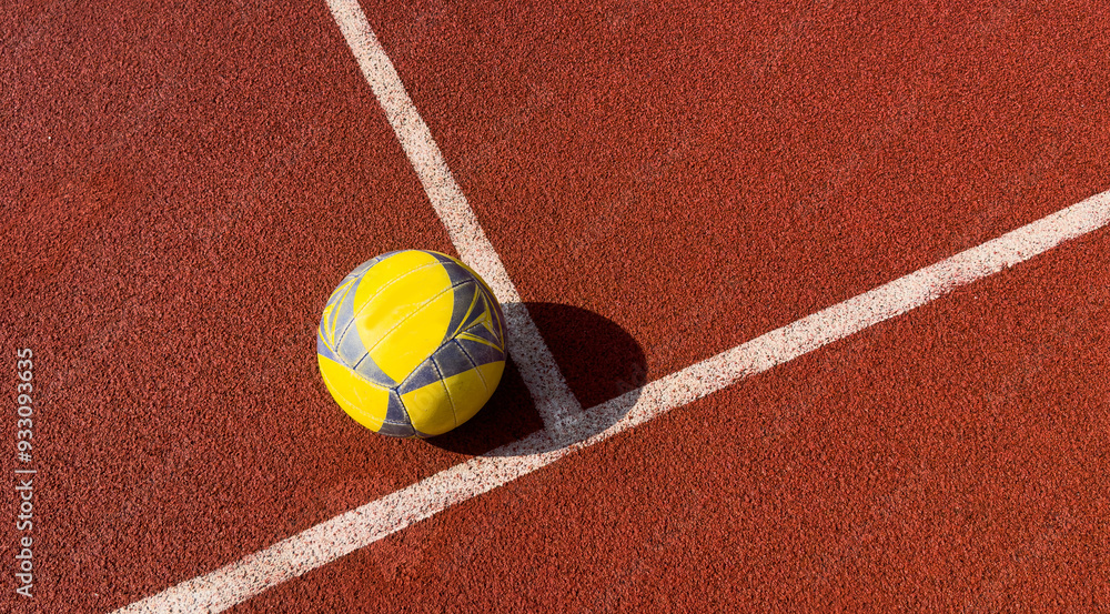 Fototapeta premium Volleyball ball and white line on court. Horizontal education and sport poster, greeting cards, headers, website