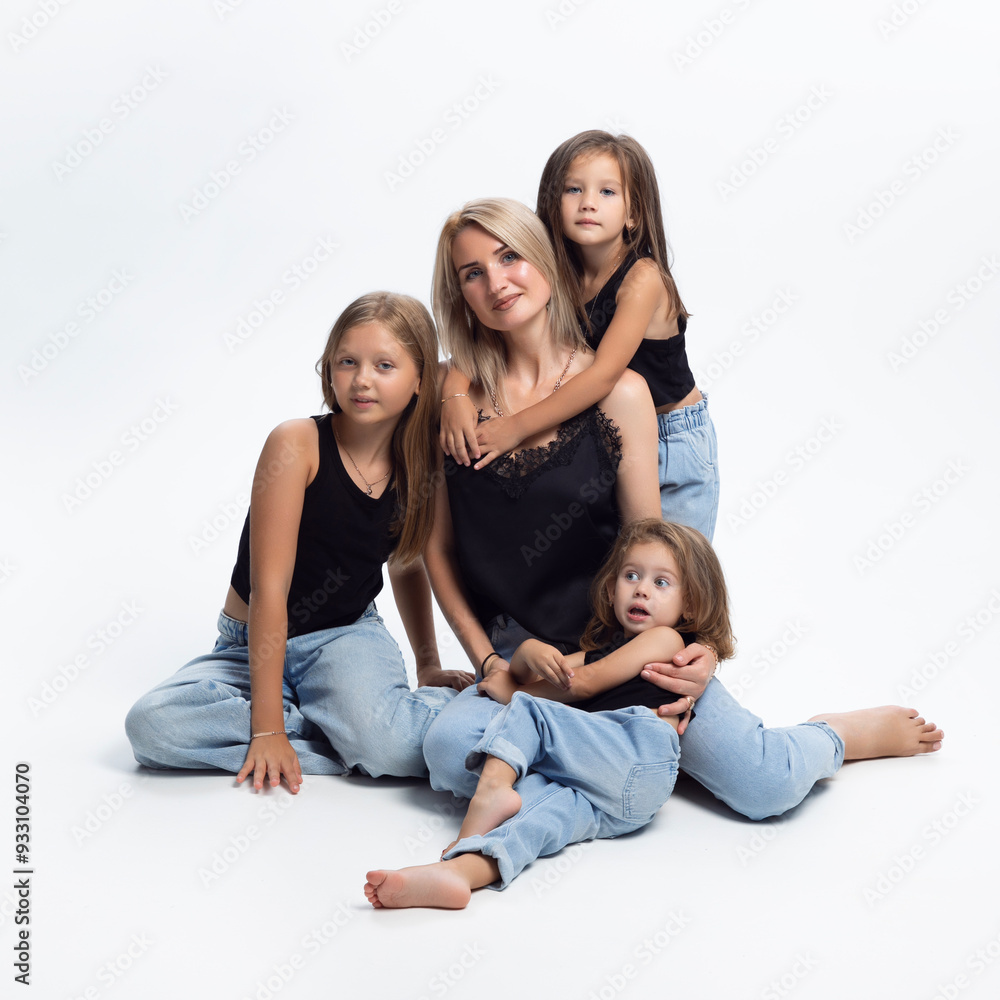 Group photo of a blonde mother with three adorables daughters, lying on a floor, isolated on a white background. Group photo of a blonde mother with three adorables daughters, lying on a floor, isolated on a white background.