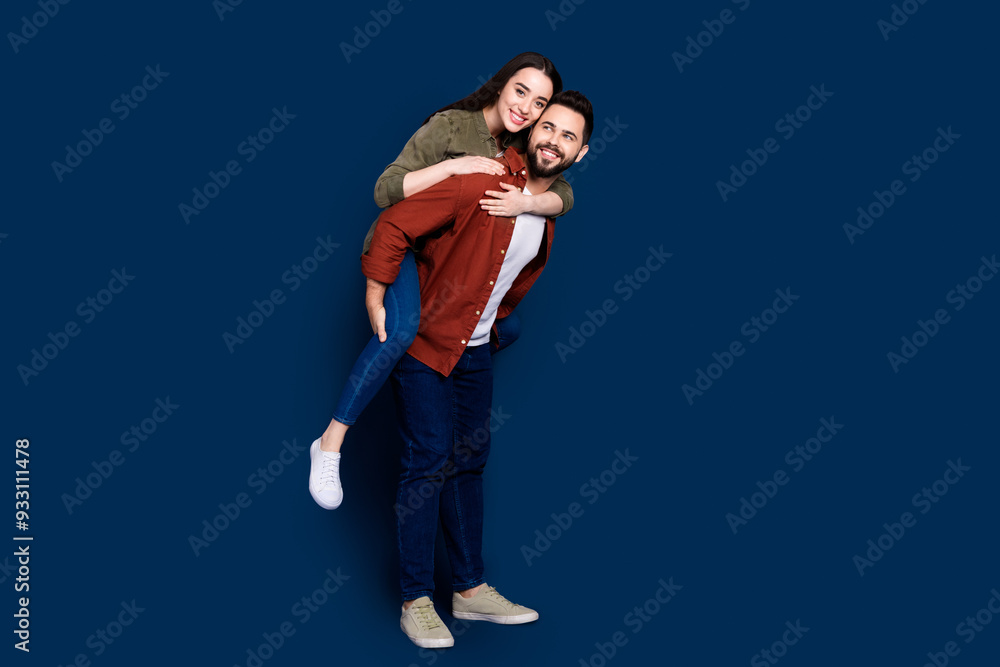 Fototapeta premium Photo of cheerful positive married couple wife husband wear stylish clothes mall store isolated on dark blue color background