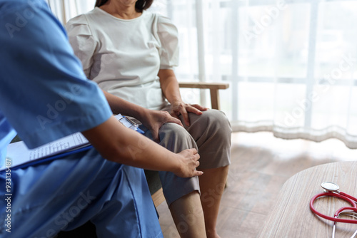 Female patient with female physical therapist, Asian doctor holding knees sitting on sofa doing physical therapy, restoring weak muscles. Pain in the clinic or hospital.