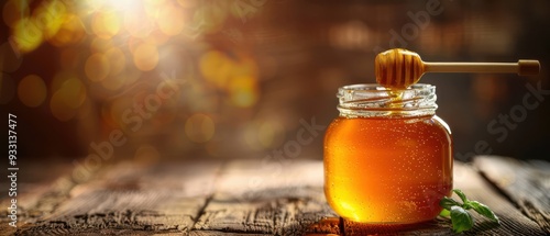 Jar of golden honey with a honey dipper on a rustic wooden table, representing natural sweetness. Free copy space for text.
