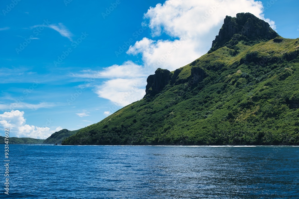 Lush green hills of volcanic islands of the Yasawa archipelago, Fiji. Beautiful, paradise-like small islands close to the main islands of Fiji. Tropical paradise and a luxurious tourist destination. Lush green hills of volcanic islands of the Yasawa archipelago, Fiji. Beautiful, paradise-like small islands close to the main islands of Fiji. Tropical paradise and a luxurious tourist destination.