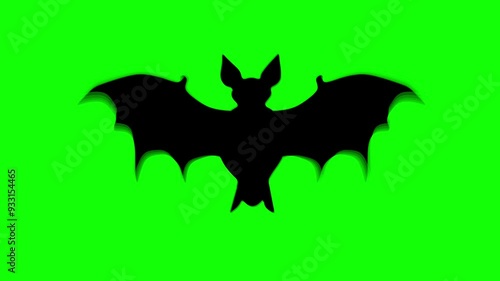 A single Halloween bat animated against a green background. Seamless loop animation with motion blur