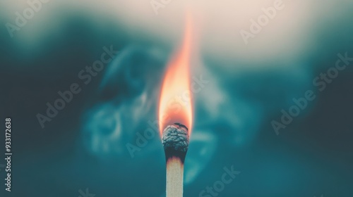 A matchstick catches fire, producing a glowing flame surrounded by swirling smoke against a hazy backdrop