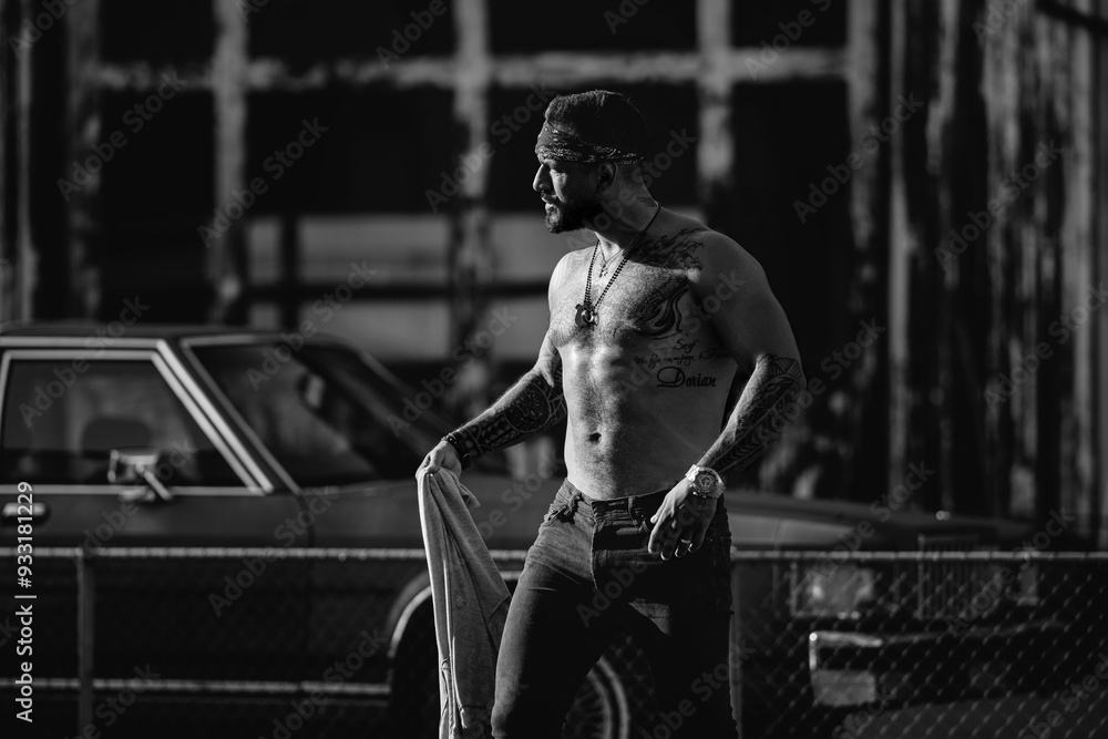 Naklejka premium Strong muscular hipster model on the street. Topless man. Fashion male posing on street. Angry Man on urban street. Dangerous aggressive man. Criminal city. Danger american district. Aggressive man.