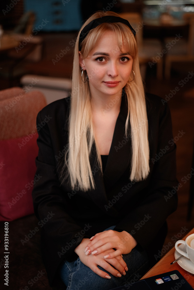 portrait of a beautiful blonde in black in a cafe portrait of a beautiful blonde in black in a cafe