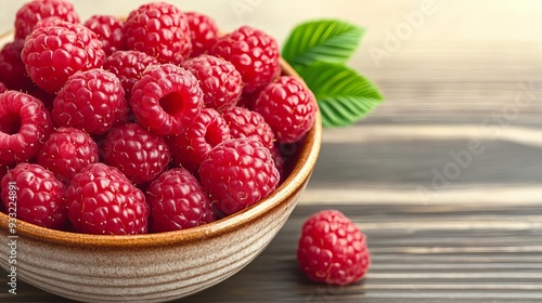 Freshly picked organic raspberries in a ceramic bowl, raspberry superfood, natural antioxidant and fiber source