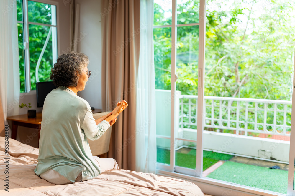 Asian senior mature woman sit on the bed suffering from finger wrist hand pain. Unhappy elderly feeling pain in joint and tendon from rheumatoid arthritis, osteoarthritis and peripheral neuropathy. Asian senior mature woman sit on the bed suffering from finger wrist hand pain. Unhappy elderly feeling pain in joint and tendon from rheumatoid arthritis, osteoarthritis and peripheral neuropathy.