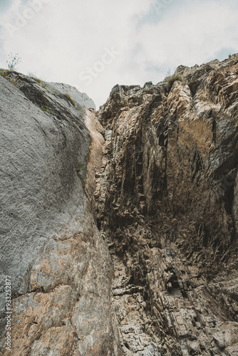 Rugged rock formations rise dramatically against a cloudy sky in the Altai Mountains, showcasing the area's natural beauty and geological features photo