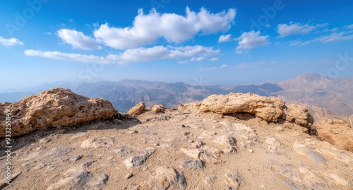 Rugged desert landscape with dramatic clouds and mountains