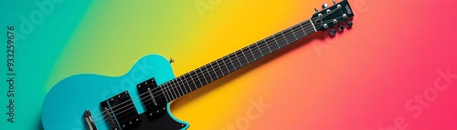 Blue electric guitar on colorful background.