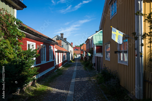 Old wooden houses and small Swedish flags in Gamla Gefle historical district of Gävle, Sweden
