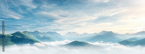  From atop a hill, gaze upon a mountain range against the mid-sky backdrop Clouds unfurl in the foreground