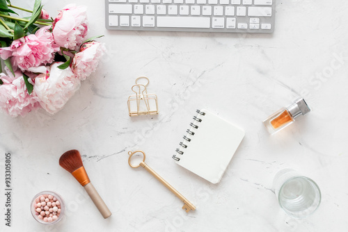 White working office table background with peony flowers and female accessories photo