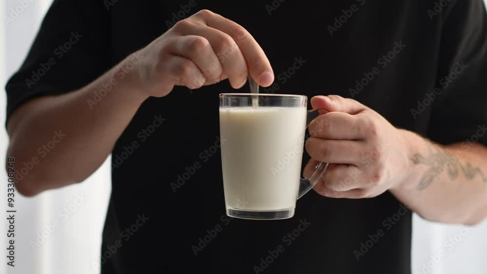 A glass of milk and a teaspoon of cereals.
Milkshake in a cup A glass of milk and a teaspoon of cereals.
Milkshake in a cup