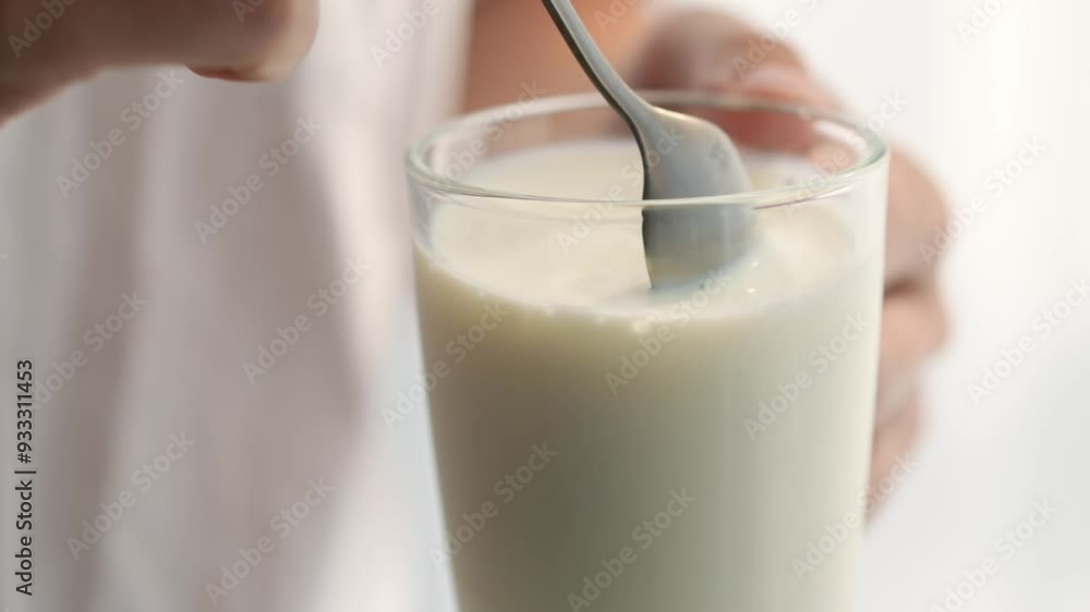 A glass of milk and a teaspoon of cereals.
Milkshake in a cup A glass of milk and a teaspoon of cereals.
Milkshake in a cup