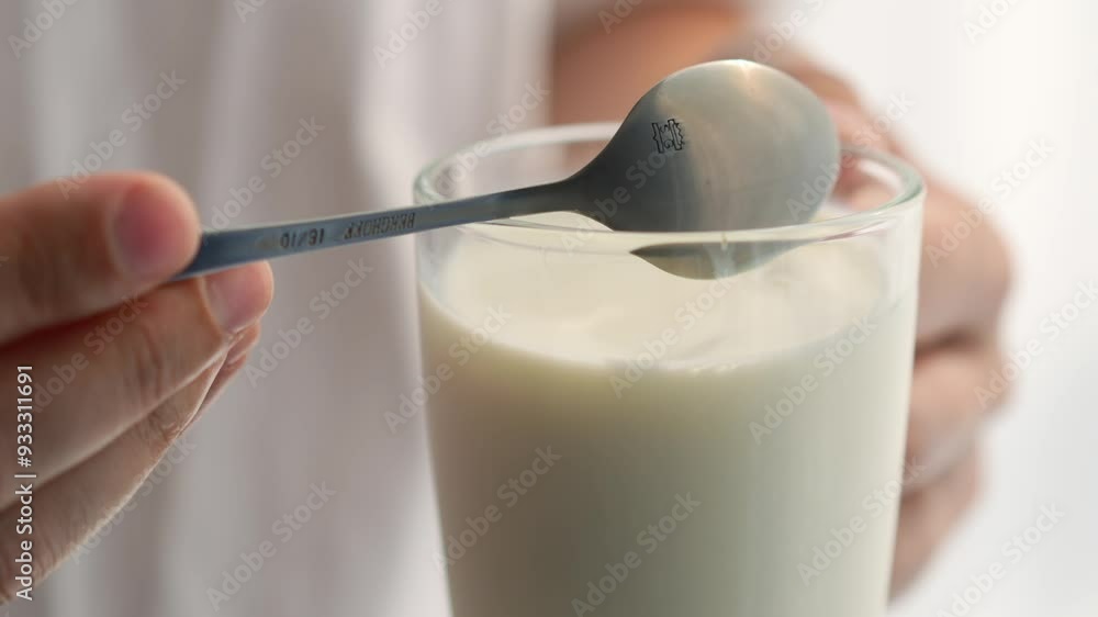 A glass of milk and a teaspoon of cereals.
Milkshake in a cup A glass of milk and a teaspoon of cereals.
Milkshake in a cup