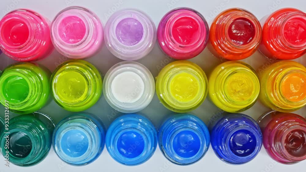 A top-down view of an organized collection of vibrant paint pots arranged in a colorful grid. Each jar is filled with bright, vivid hues, representing a full spectrum of colors, perfect for artistic A top-down view of an organized collection of vibrant paint pots arranged in a colorful grid. Each jar is filled with bright, vivid hues, representing a full spectrum of colors, perfect for artistic