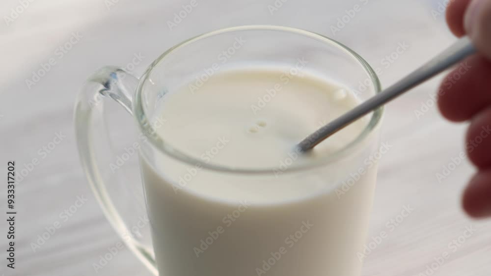 A glass of milk and a teaspoon of cereals.
Milkshake in a cup A glass of milk and a teaspoon of cereals.
Milkshake in a cup