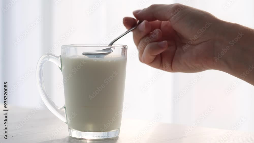 A glass of milk and a teaspoon of cereals.
Milkshake in a cup A glass of milk and a teaspoon of cereals.
Milkshake in a cup