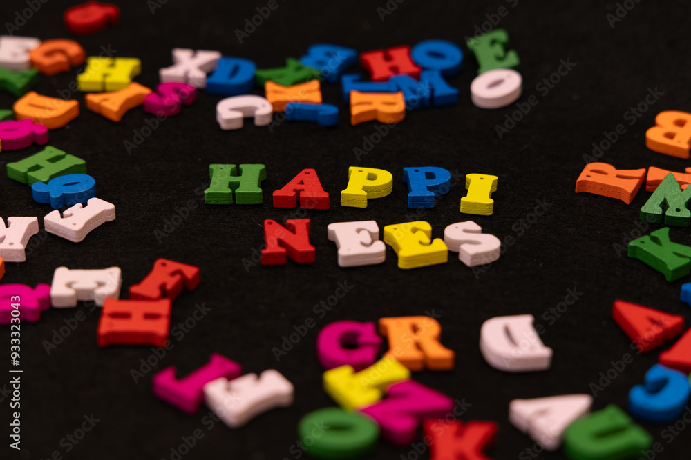 Naklejka premium Wooden letters in multiple colors spell out 