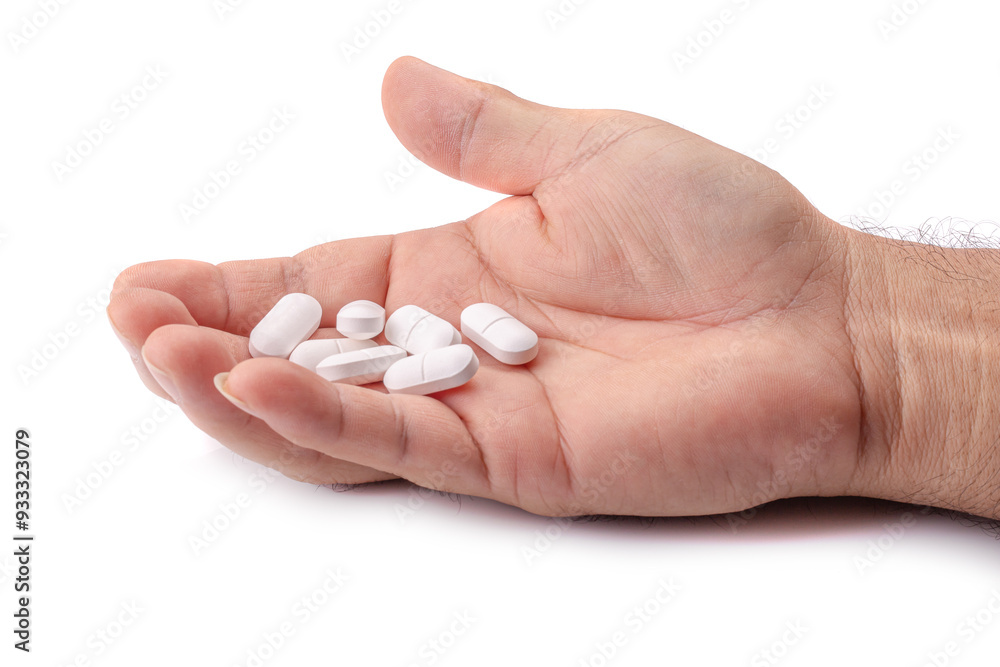 Hand holding many paracetamol tablets isolated on white background. Hand holding many paracetamol tablets isolated on white background.