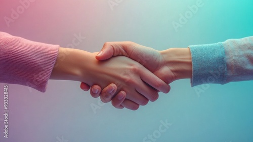 Two individuals engaged in a handshake, signifying mutual respect and agreement in a professional setting.