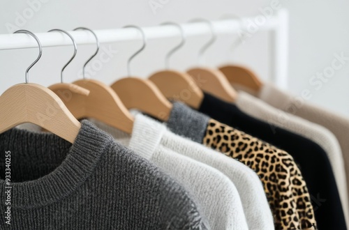 Cozy sweaters displayed on hangers in a minimalist indoor setting