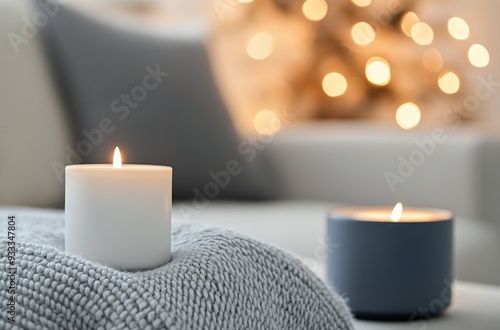 Cozy living room setting with lit candles and soft blankets during festive se...