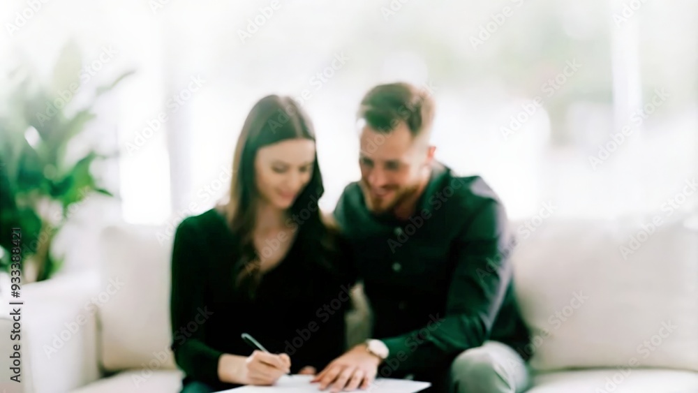 Close up of couple sign on contract sitting on sofa, copy space Close up of couple sign on contract sitting on sofa, copy space