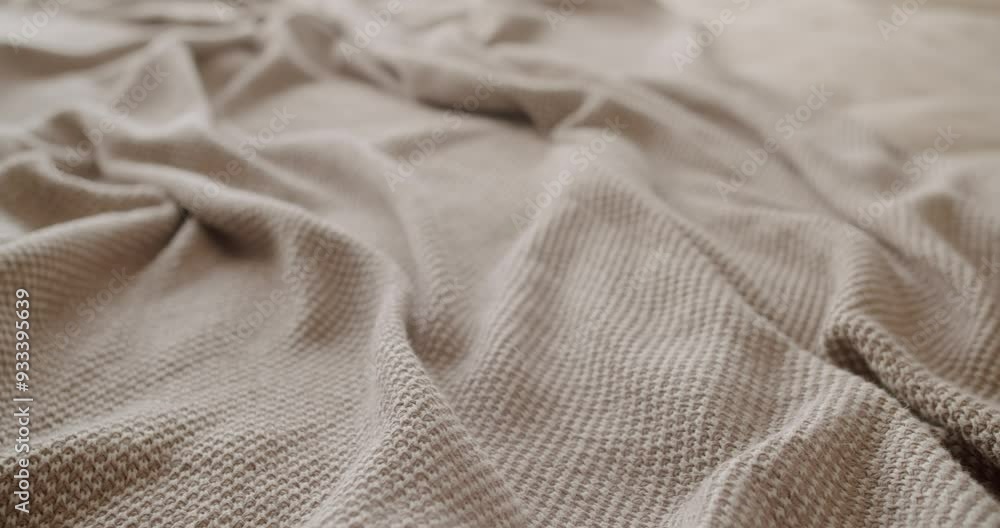 Close-up view of a cozy folded beige blanket with a soft wavy texture. The image evokes warmth, comfort, and relaxation, ideal for home decor and lifestyle concepts. Cozy Soft Blanket on a Bed Close-up view of a cozy folded beige blanket with a soft wavy texture. The image evokes warmth, comfort, and relaxation, ideal for home decor and lifestyle concepts. Cozy Soft Blanket on a Bed