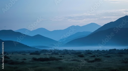 A serene landscape with indigo mountains in the distance, bathed in twilight