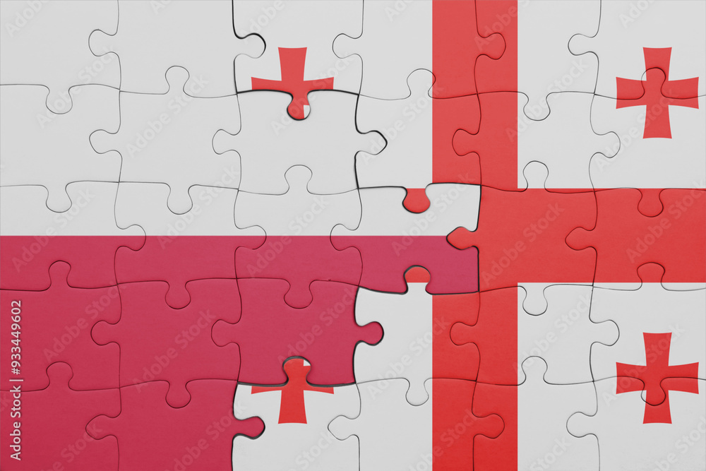 puzzle with the colourful national flag of georgia and flag of poland.