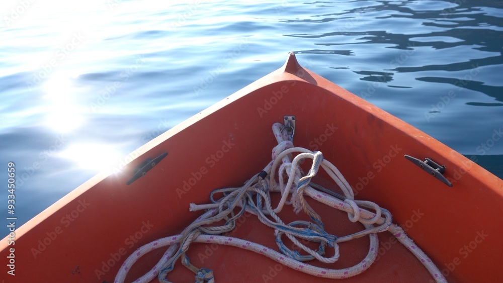 small boat sailing in the sea with calm water and sun reflection reflected in the water, boat ride in summer. sail in calm waters and relax in the sun
