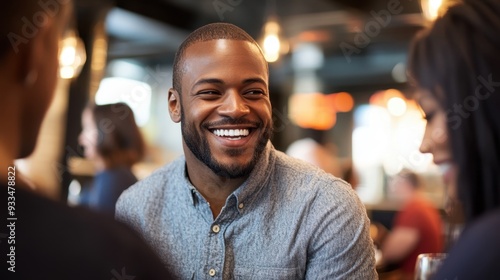 Cheerful Young Man Enjoying Conversation in Cafe Setting