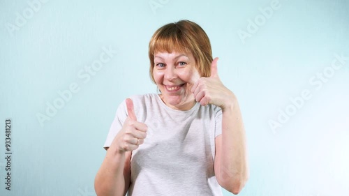 Wallpaper Mural The girl smiles at the camera and shows thumbs up. Positive emotions - joy and luck. Torontodigital.ca