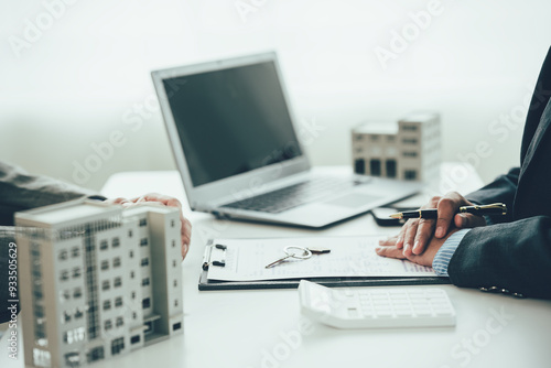 Wallpaper Mural A real estate agent is explaining the layout of a house to a client who is about to buy a new apartment along with insurance interest rates on the title. Close-up photo Torontodigital.ca