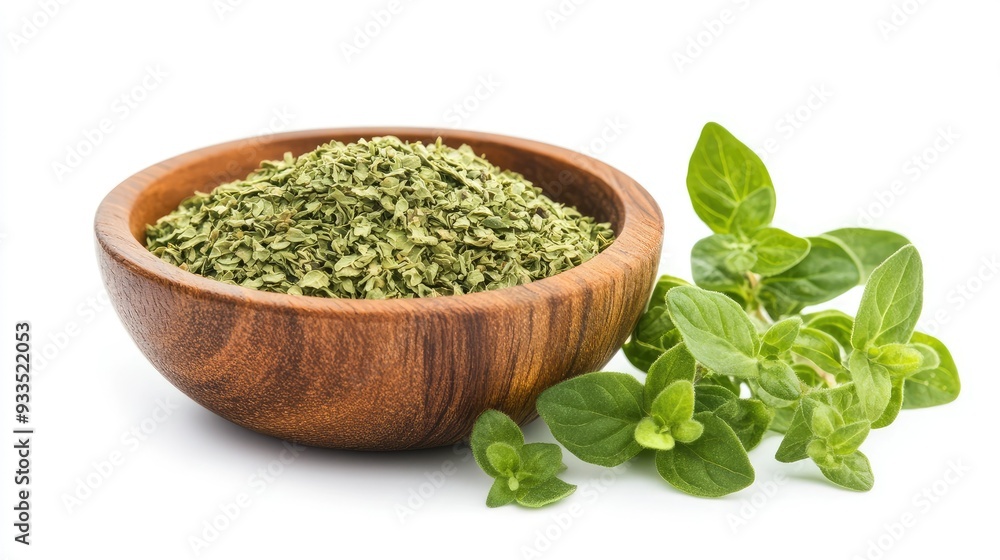 A rustic wooden bowl filled with dried oregano flakes, paired with fresh oregano leaves, all isolated on a white background for a clean, natural look. A rustic wooden bowl filled with dried oregano flakes, paired with fresh oregano leaves, all isolated on a white background for a clean, natural look.