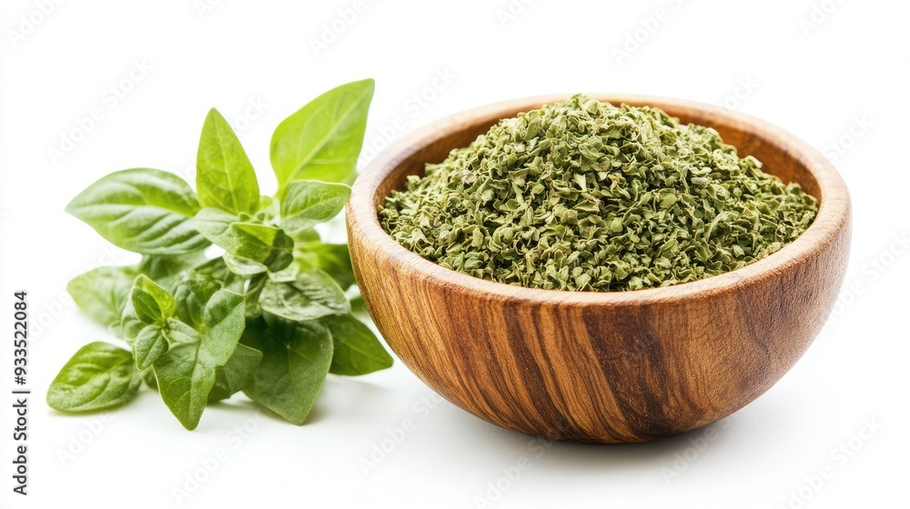 A rustic wooden bowl filled with dried oregano flakes, complemented by fresh oregano leaves, all neatly arranged and isolated on a white background. A rustic wooden bowl filled with dried oregano flakes, complemented by fresh oregano leaves, all neatly arranged and isolated on a white background.