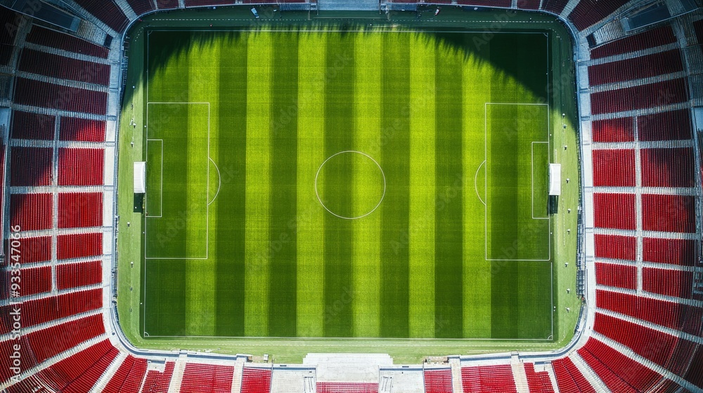 Obraz premium Top view of a soccer stadium with empty stands highlighting the symmetry of the field and seats. Copy space available