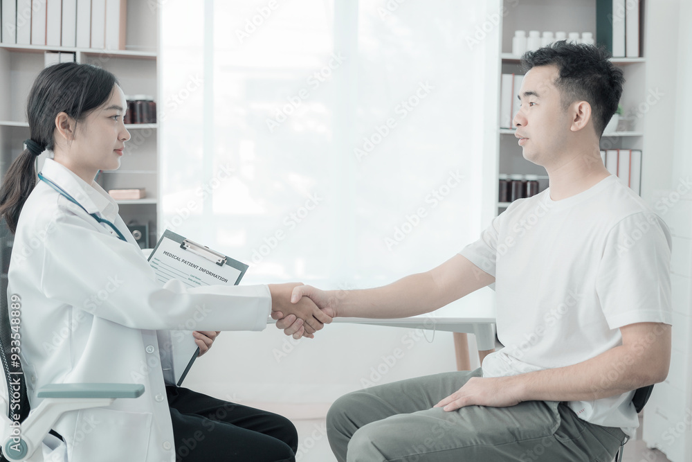 Obraz premium Asian female nurse talking and asking about symptoms of young male patient using blood pressure monitor to measure blood pressure level Medical examination result during consultation