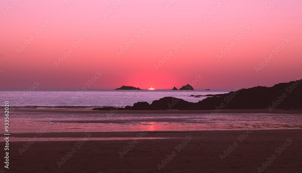 Vibrant pink sunset over a tranquil beach with rocky silhouettes and calm ocean waters – a serene coastal landscape at twilight scene with reflections on the sand and a stunning pastel sky, Norfolk UK Vibrant pink sunset over a tranquil beach with rocky silhouettes and calm ocean waters – a serene coastal landscape at twilight scene with reflections on the sand and a stunning pastel sky, Norfolk UK