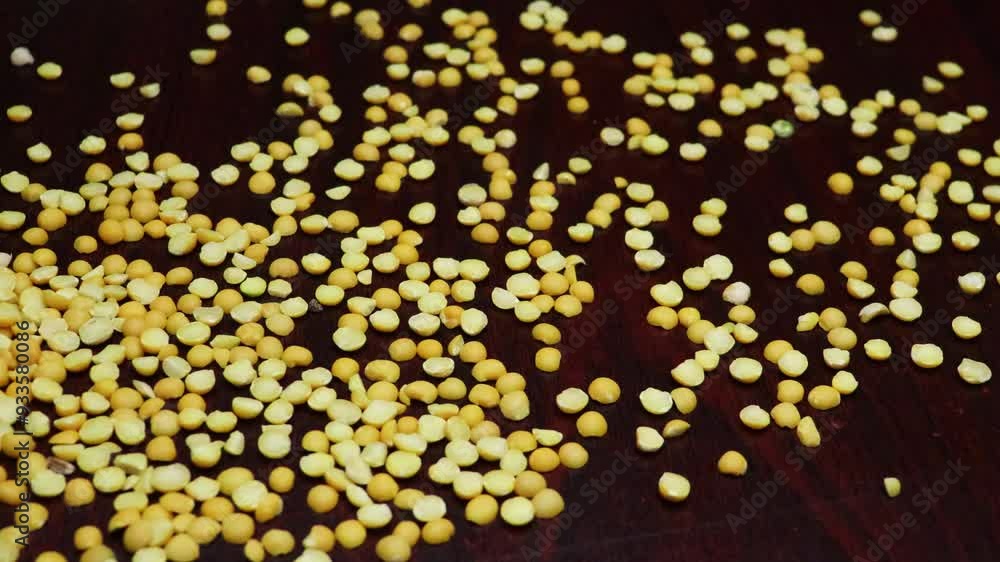 Dried yellow peas scatter on black board 4k footage. Pigeon peas, Arhar legume disperse. Slow motion.
Dried yellow peas scatter on black board 4k footage. Pigeon peas, Arhar legume disperse. Slow motion.